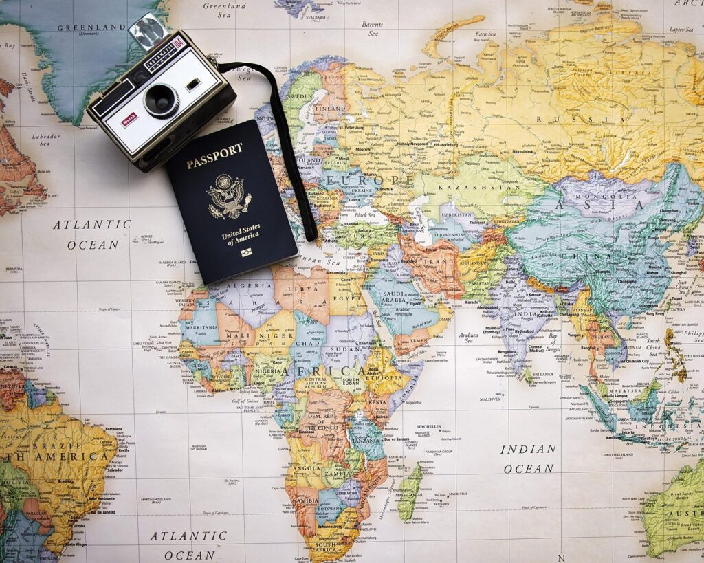 Featured image for off-season travel pillar content includes passport, map, world, trip, tourism, world map, vacation, travel, planning, camera