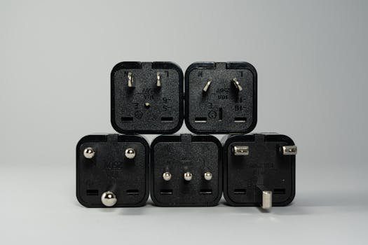 pexels-photo-3639031-3639031 A collection of various black international power plug adapters for global electronics use.